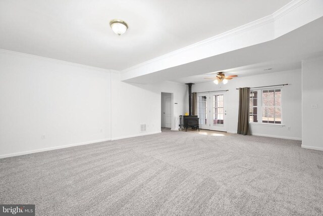 5519 Bazzanella Dr, Mineral, VA 23117 - unfurnished living room with a wood stove, ornamental molding, carpet flooring, baseboards, and a ceiling fan