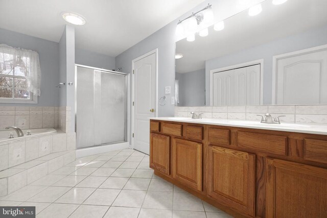 5519 Bazzanella Dr, Mineral, VA 23117 - bathroom with tile patterned floors, a stall shower, double vanity, a bath, and decorative backsplash