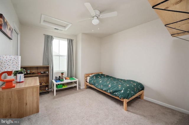 bedroom with attic access, light carpet, and baseboards