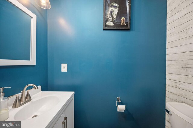 2245 Walnut Branch Dr, Culpeper, VA 22701 - bathroom featuring wooden walls, toilet, and vanity