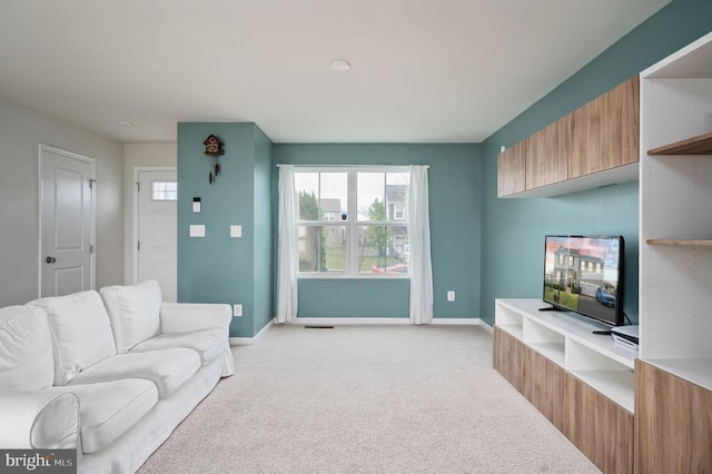 living room with light carpet and baseboards