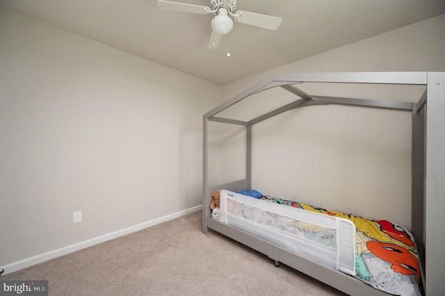 bedroom with carpet, baseboards, vaulted ceiling, and ceiling fan