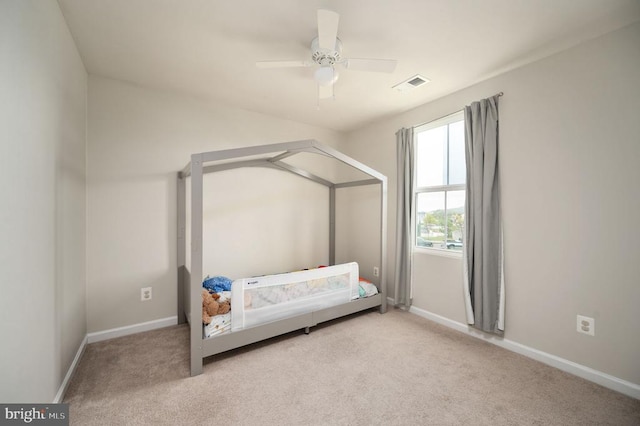 carpeted bedroom featuring baseboards and ceiling fan