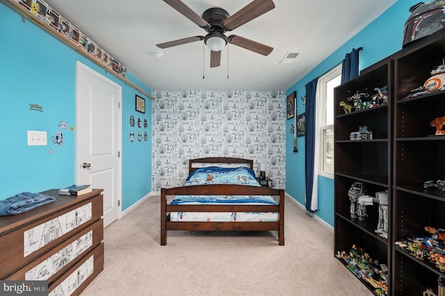 carpeted bedroom featuring ceiling fan and baseboards