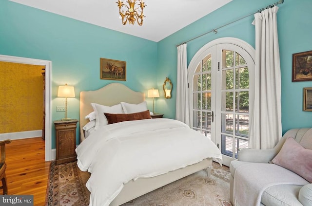 8833 Wales Rd N, Warrenton, VA 20186 - bedroom featuring wood finished floors and a chandelier