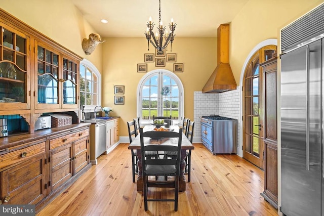 8833 Wales Rd N, Warrenton, VA 20186 - dining room featuring a chandelier, light wood-style flooring, recessed lighting, and a high ceiling