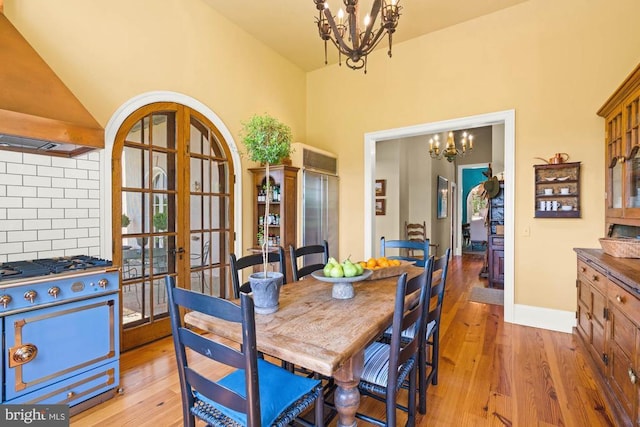 8833 Wales Rd N, Warrenton, VA 20186 - dining room featuring a chandelier, light wood-type flooring, a high ceiling, and french doors