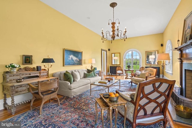 8833 Wales Rd N, Warrenton, VA 20186 - living area featuring a chandelier, wood finished floors, a high ceiling, and a fireplace with raised hearth