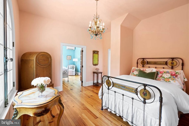 8833 Wales Rd N, Warrenton, VA 20186 - bedroom featuring a chandelier, light wood finished floors, and a wall unit AC