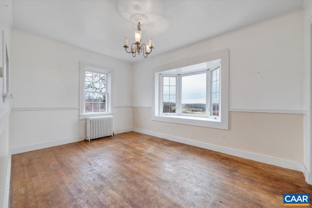 2420 James River Rd, Esmont, VA 22937 - unfurnished dining area featuring a chandelier, radiator, baseboards, and wood-type flooring
