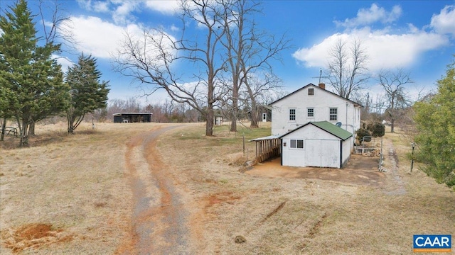 2420 James River Rd, Esmont, VA 22937 - exterior space featuring a chimney, driveway, and an outbuilding