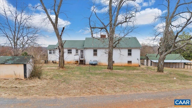 2420 James River Rd, Esmont, VA 22937 - back of house featuring an outdoor structure, a shed, entry steps, a chimney, and a lawn