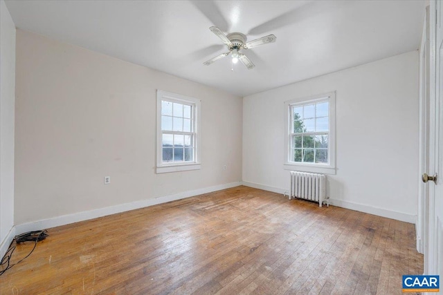 2420 James River Rd, Esmont, VA 22937 - empty room featuring ceiling fan, baseboards, hardwood / wood-style floors, and radiator heating unit