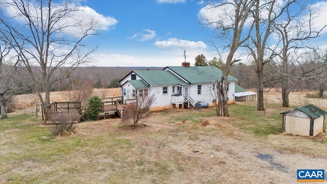 2420 James River Rd, Esmont, VA 22937 - view of front facade featuring an outbuilding, a chimney, a deck, and a storage unit
