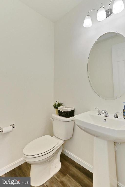 2020 Captain Dr, Fredericksburg, VA 22408 - half bath with wood finished floors, toilet, baseboards, and a sink