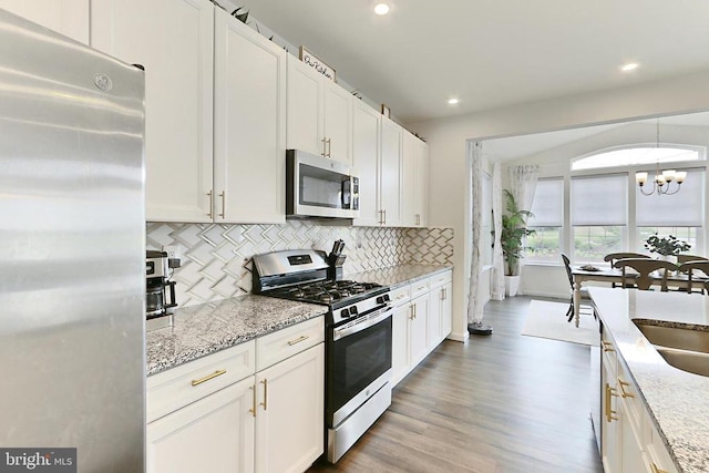 2020 Captain Dr, Fredericksburg, VA 22408 - kitchen featuring stainless steel appliances, tasteful backsplash, a chandelier, recessed lighting, and a sink