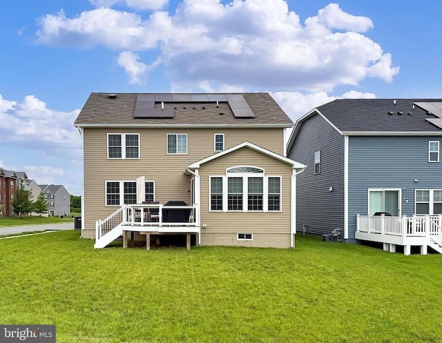 2020 Captain Dr, Fredericksburg, VA 22408 - back of house with a lawn, roof mounted solar panels, and a wooden deck