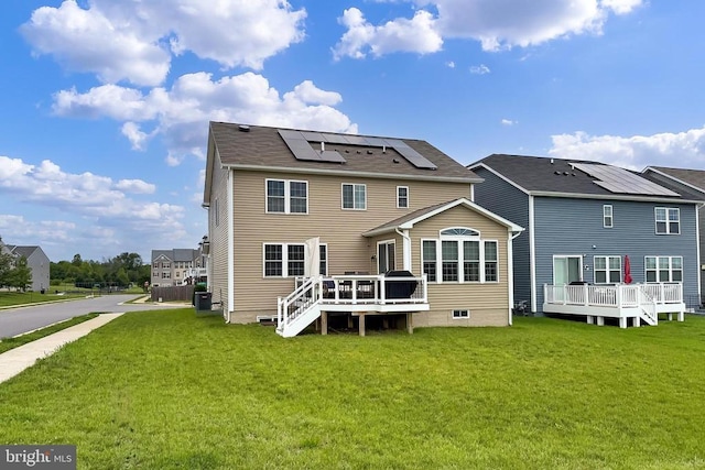 2020 Captain Dr, Fredericksburg, VA 22408 - rear view of property featuring roof mounted solar panels, a deck, and a lawn