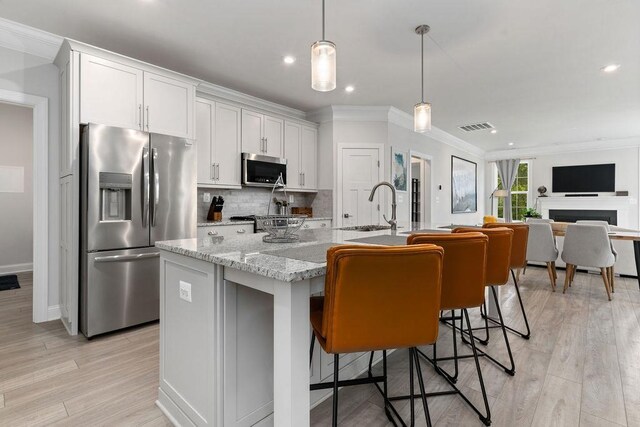120 Ridgeline Dr, Waynesboro, VA 22980 - kitchen with appliances with stainless steel finishes, crown molding, white cabinetry, backsplash, and light wood-style floors