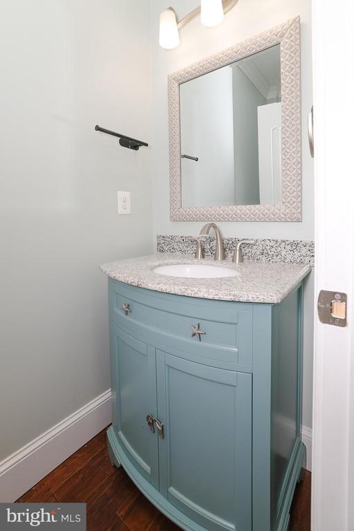 - bathroom featuring vanity, wood finished floors, and baseboards