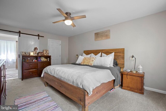 4102 Chris Shan Ct, Fredericksburg, VA 22408 - bedroom with light colored carpet, baseboards, ceiling fan, and a barn door