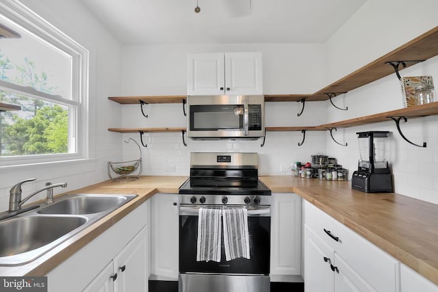 316 Wayland Rd, Culpeper, VA 22701 - kitchen with appliances with stainless steel finishes, open shelves, decorative backsplash, and white cabinets