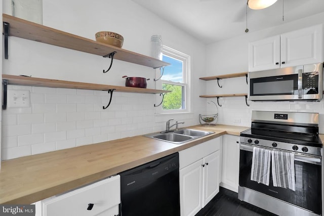 316 Wayland Rd, Culpeper, VA 22701 - kitchen with appliances with stainless steel finishes, open shelves, backsplash, white cabinetry, and wooden counters