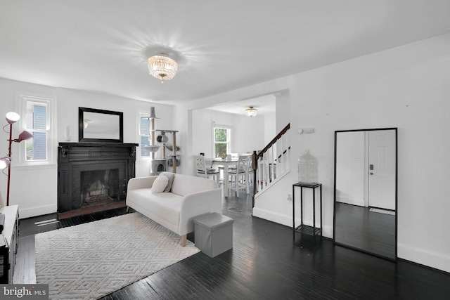 316 Wayland Rd, Culpeper, VA 22701 - living room featuring stairway, a fireplace, wood finished floors, and a chandelier