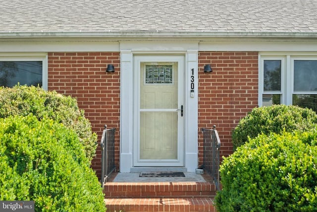 130 Morningside Dr, Culpeper, VA 22701 - view of exterior entry with a shingled roof and brick siding