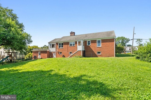 130 Morningside Dr, Culpeper, VA 22701 - rear view of house with a lawn, a chimney, a playground, and brick siding