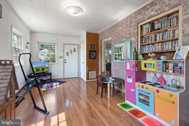 130 Morningside Dr, Culpeper, VA 22701 - playroom with wood finished floors, brick wall, and ornamental molding