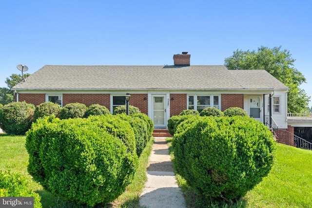 130 Morningside Dr, Culpeper, VA 22701 - view of front of property with a chimney, brick siding, a front lawn, and roof with shingles