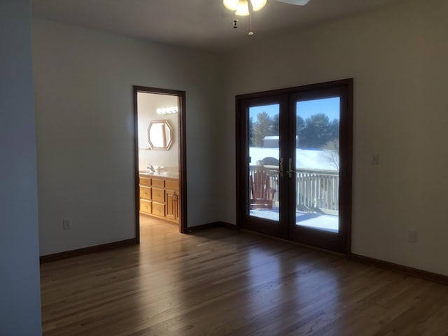 spare room featuring hardwood / wood-style flooring and french doors