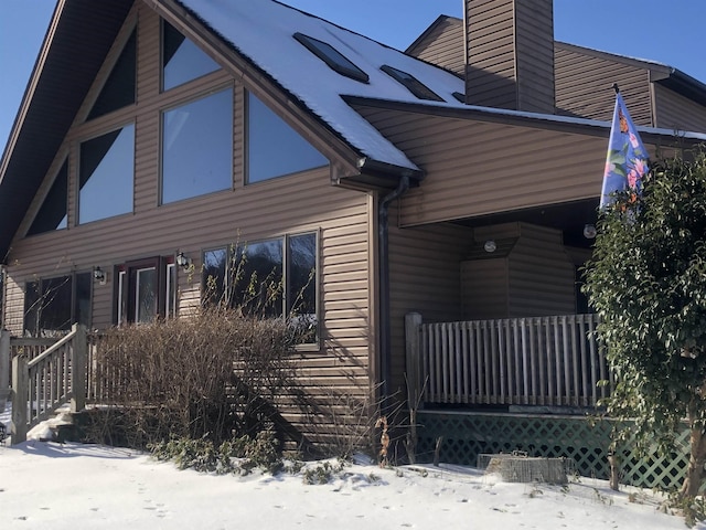 view of snow covered exterior featuring a porch