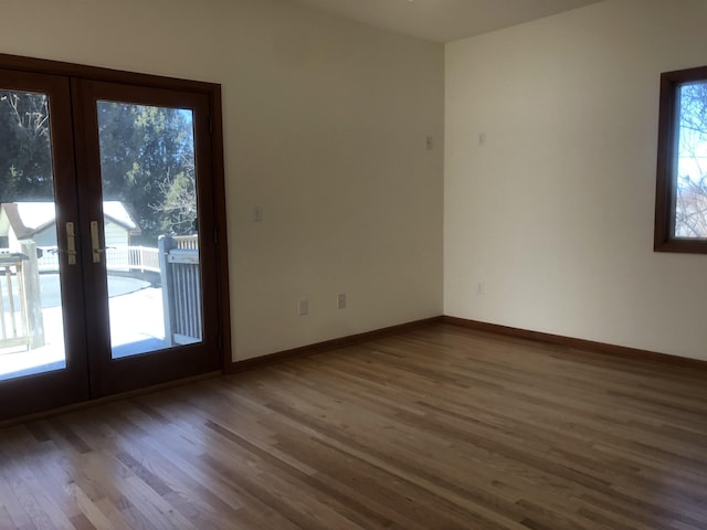 empty room with wood-type flooring and french doors