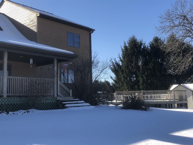 view of snow covered exterior featuring covered porch