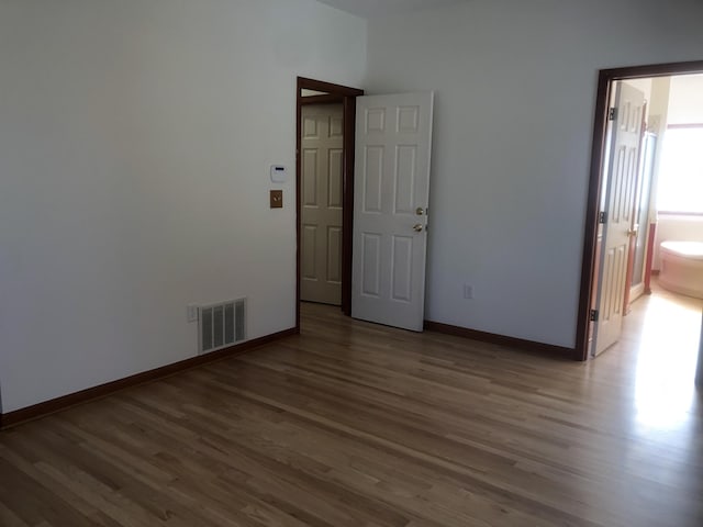 empty room featuring hardwood / wood-style flooring