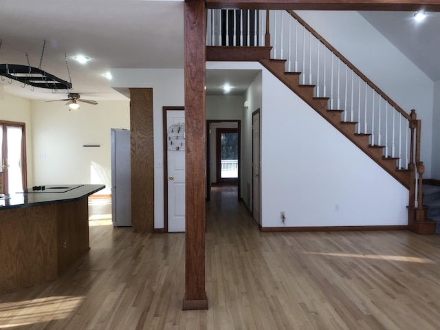 interior space featuring black electric cooktop, ceiling fan, and hardwood / wood-style floors