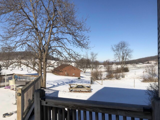 yard layered in snow with a deck