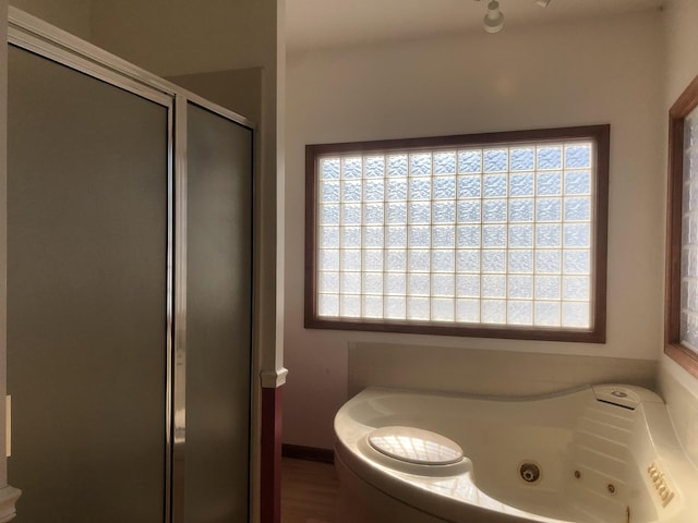 bathroom featuring separate shower and tub