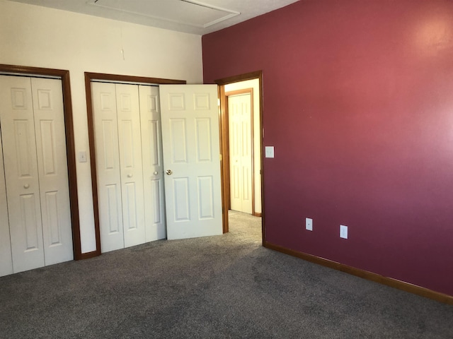 unfurnished bedroom with carpet and two closets