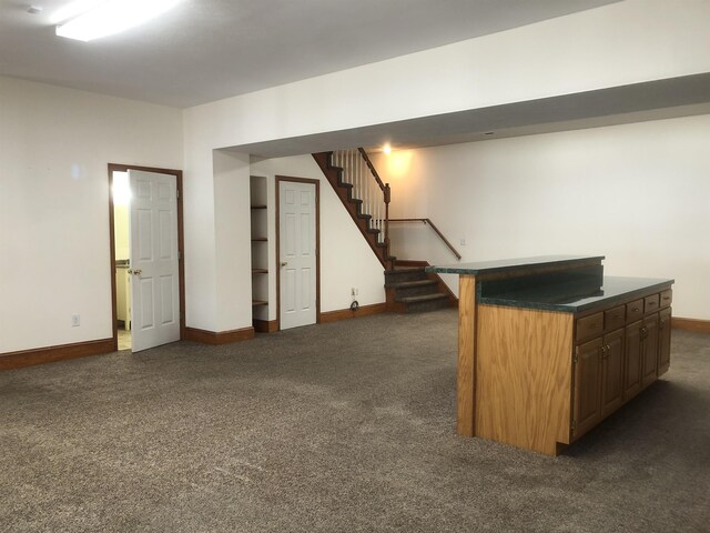 interior space featuring dark colored carpet