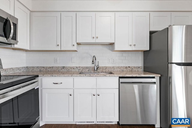 38 Firtree Dr, Wintergreen, VA 22967 - kitchen featuring a sink, stainless steel appliances, decorative backsplash, and white cabinets