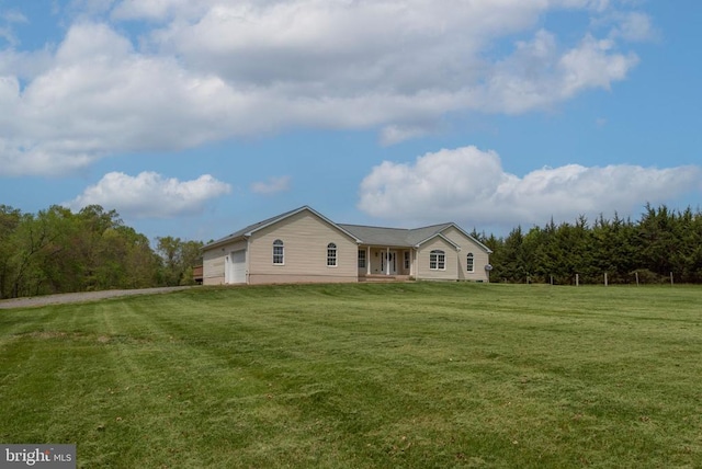  - view of front of home with a front yard and a garage