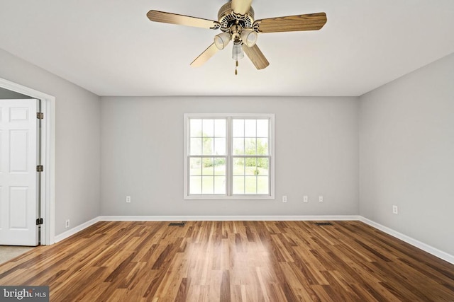  - unfurnished room featuring baseboards, wood finished floors, and ceiling fan