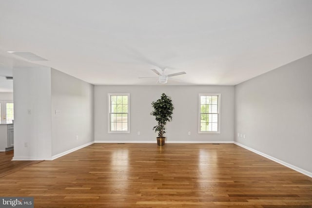  - empty room featuring a ceiling fan, wood finished floors, and baseboards