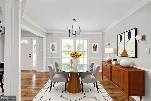  - dining space with a chandelier, light wood-style flooring, baseboards, and ornamental molding