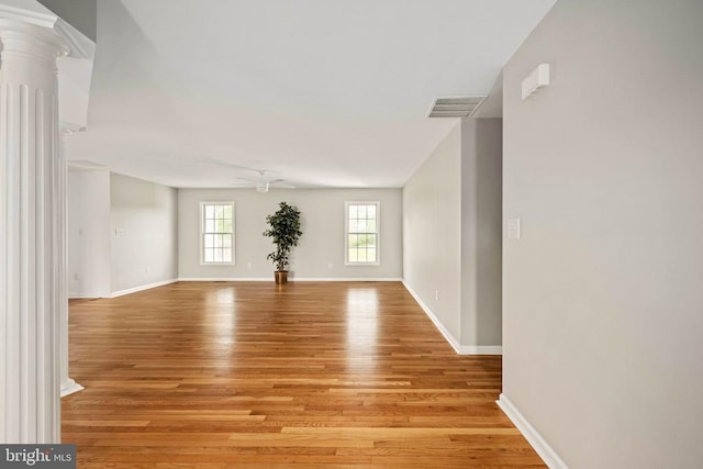  - empty room with light wood finished floors, ceiling fan, and baseboards