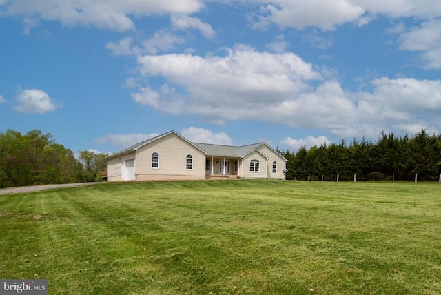  - view of front of house featuring a front lawn and an attached garage