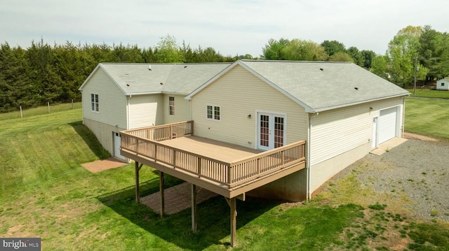  - back of house featuring french doors, a wooden deck, a yard, and a garage